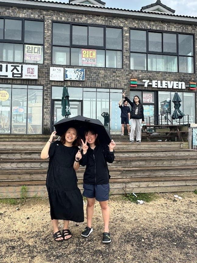 Korea- Students and fellow volunteer after surfing